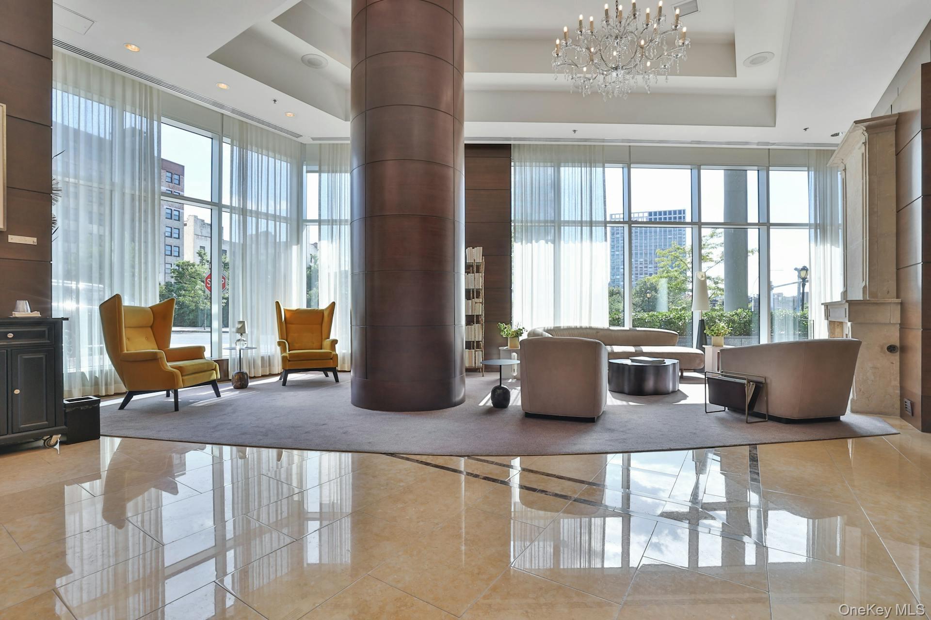 5 Renaissance Square, Unit 12A White Plains, NY 10601 - Photo 32 of 36 a living room with furniture and large windows