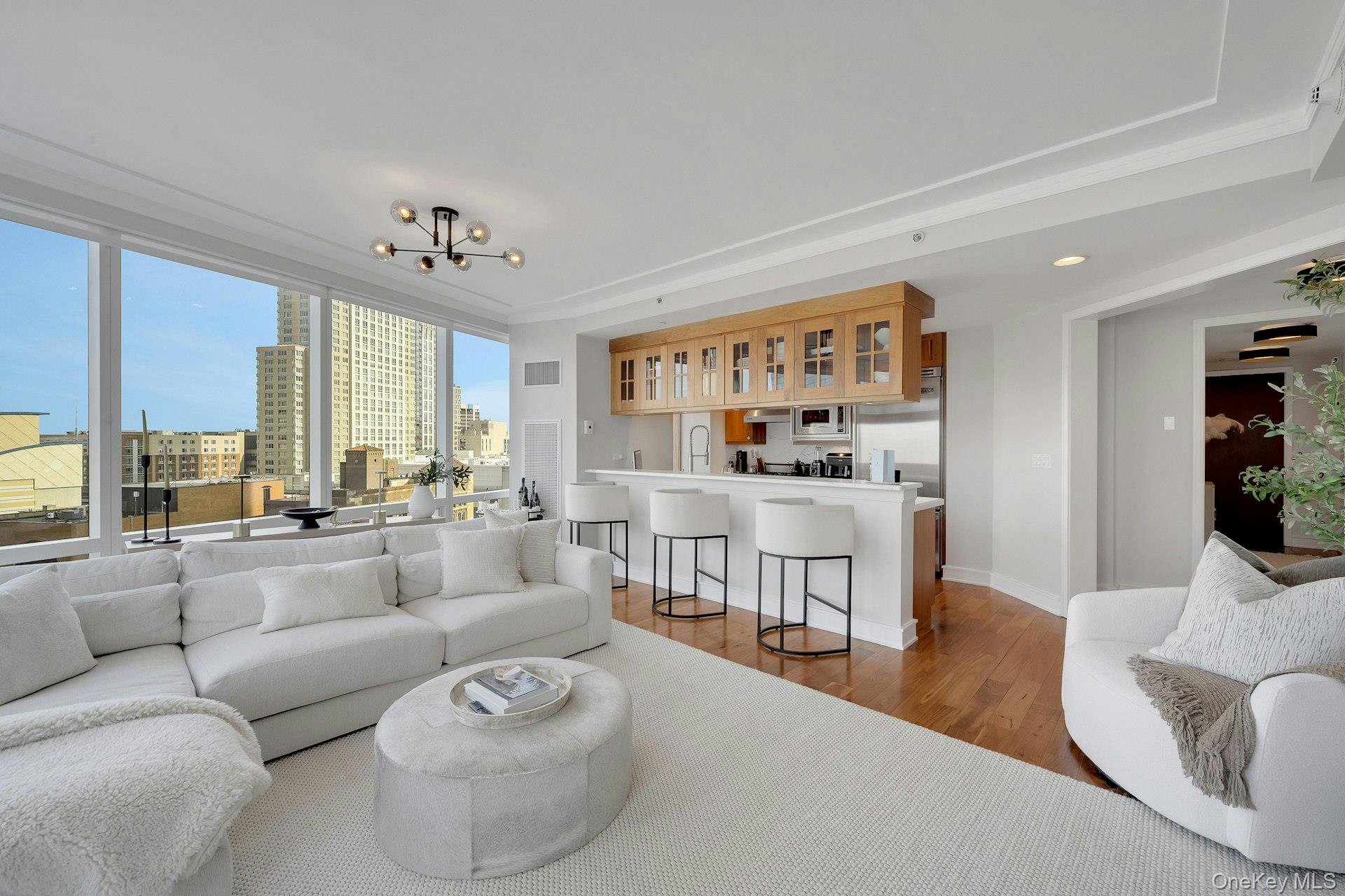 5 Renaissance Square, Unit 12A White Plains, NY 10601 - Photo 5 of 36 a living room with furniture and a large window