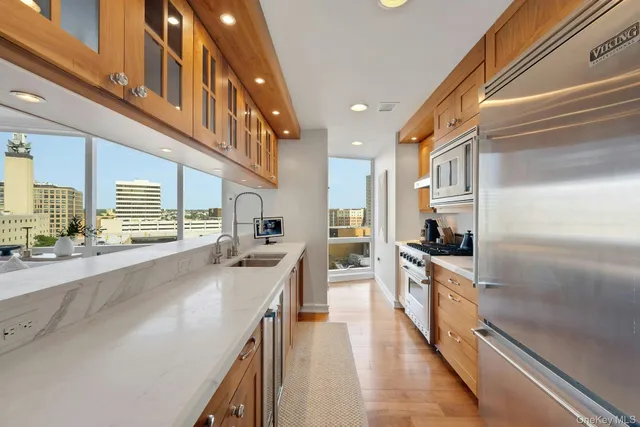 a kitchen with stainless steel appliances granite countertop a sink and a stove