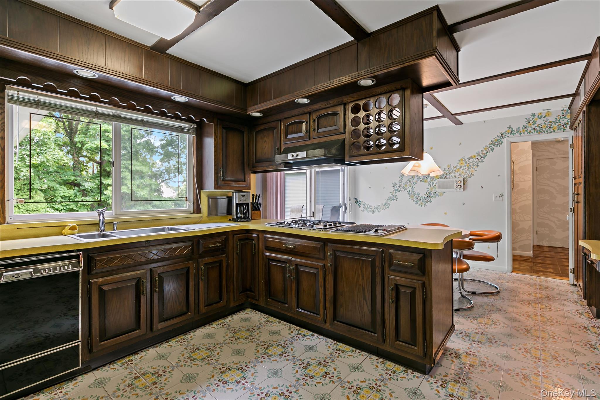 16 Meadow Road Scarsdale, NY 10583 - Photo 12 of 47 a kitchen with a sink and wooden cabinets