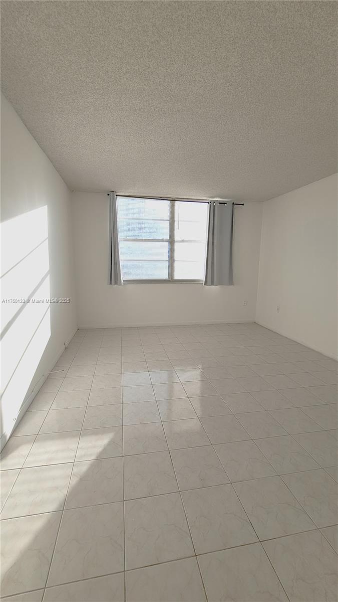 2801 Northeast 183rd Street, Unit 504W Aventura, FL 33160 - Photo 12 of 36 an empty room with windows and entrance