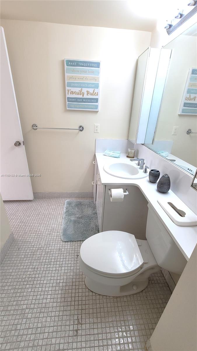 2801 Northeast 183rd Street, Unit 504W Aventura, FL 33160 - Photo 20 of 36 a bathroom with a toilet sink and mirror