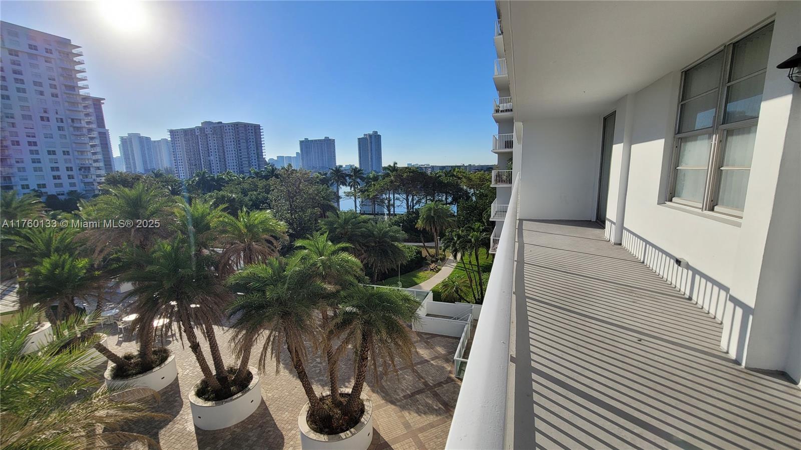 2801 Northeast 183rd Street, Unit 504W Aventura, FL 33160 - Photo 35 of 36 a view of balcony with potted plants and wooden walls