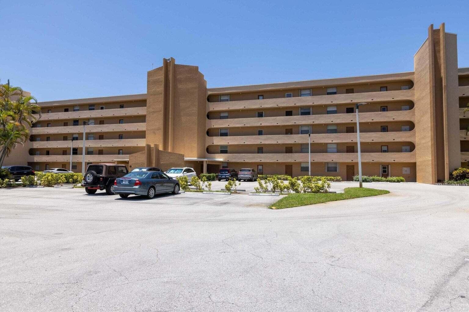 299 Northwest 52nd Terrace, Unit 118 Boca Raton, FL 33487 - Photo 2 of 28 a view of street with large building