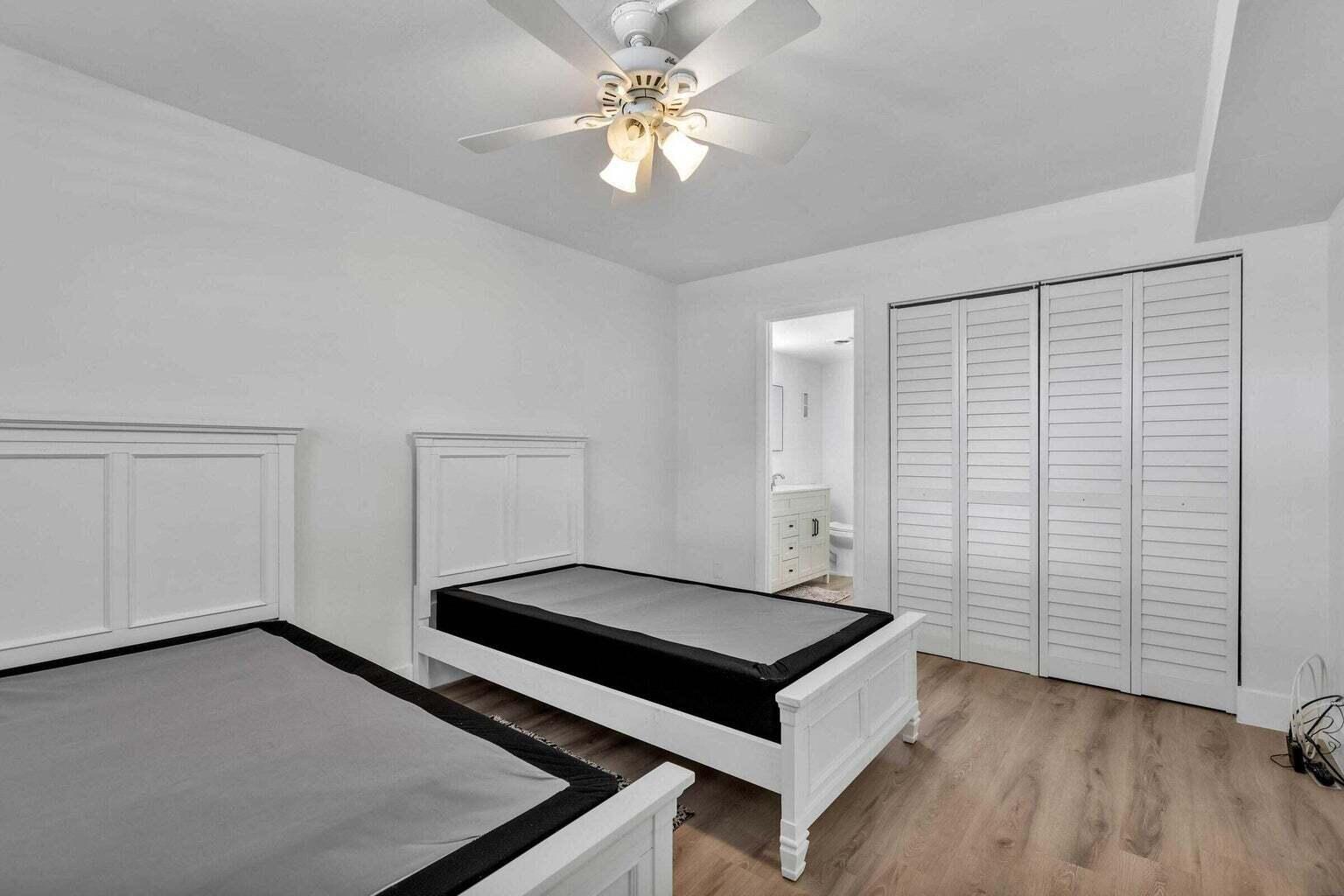 299 Northwest 52nd Terrace, Unit 118 Boca Raton, FL 33487 - Photo 21 of 28 wooden floor in an empty room with a window