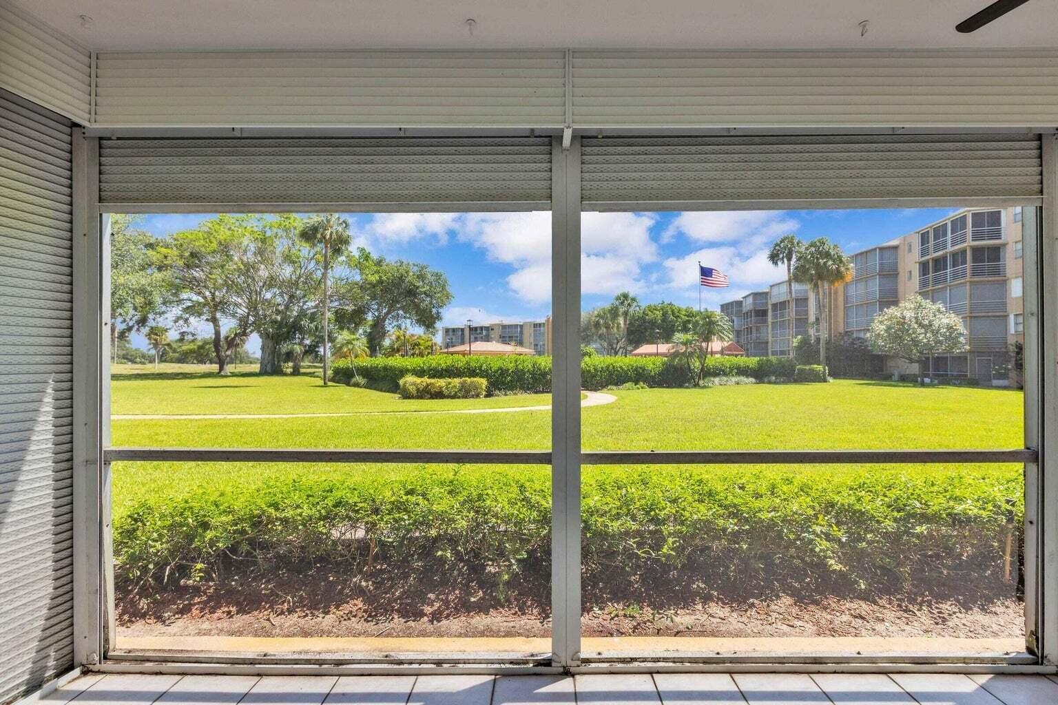 299 Northwest 52nd Terrace, Unit 118 Boca Raton, FL 33487 - Photo 25 of 28 a view of a porch with a yard