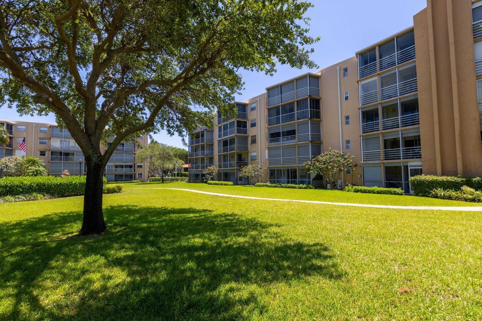 299 Northwest 52nd Terrace, Unit 118 Boca Raton, FL 33487 - Photo 28 of 28 a swimming pool with outdoor seating and yard