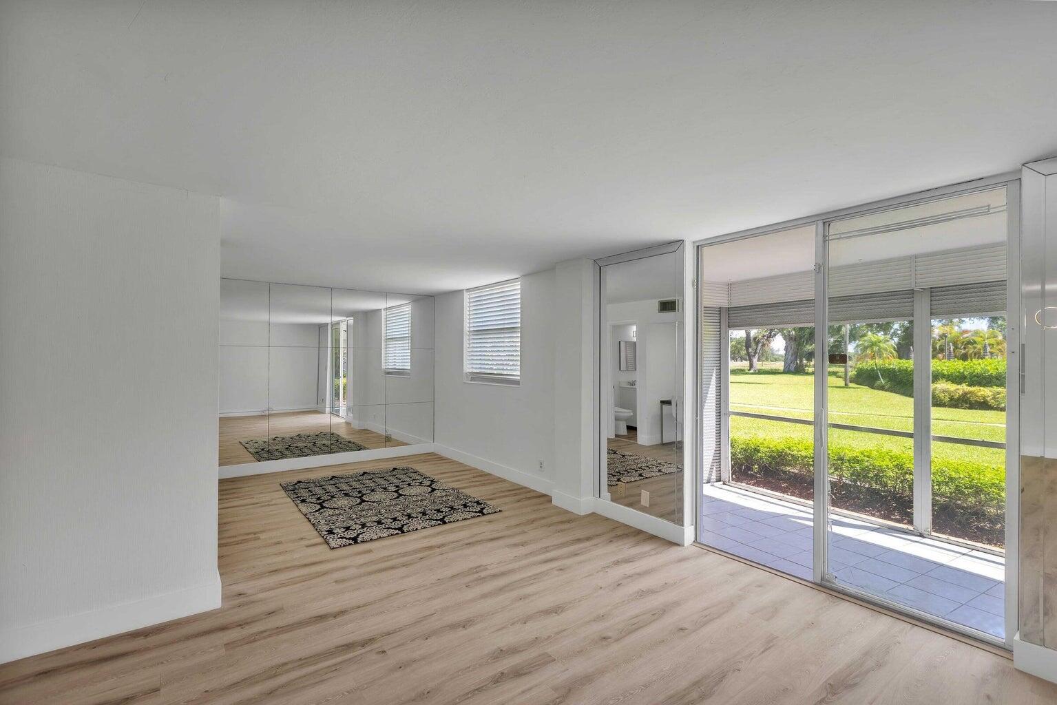 299 Northwest 52nd Terrace, Unit 118 Boca Raton, FL 33487 - Photo 5 of 28 a view of a bedroom with furniture and window