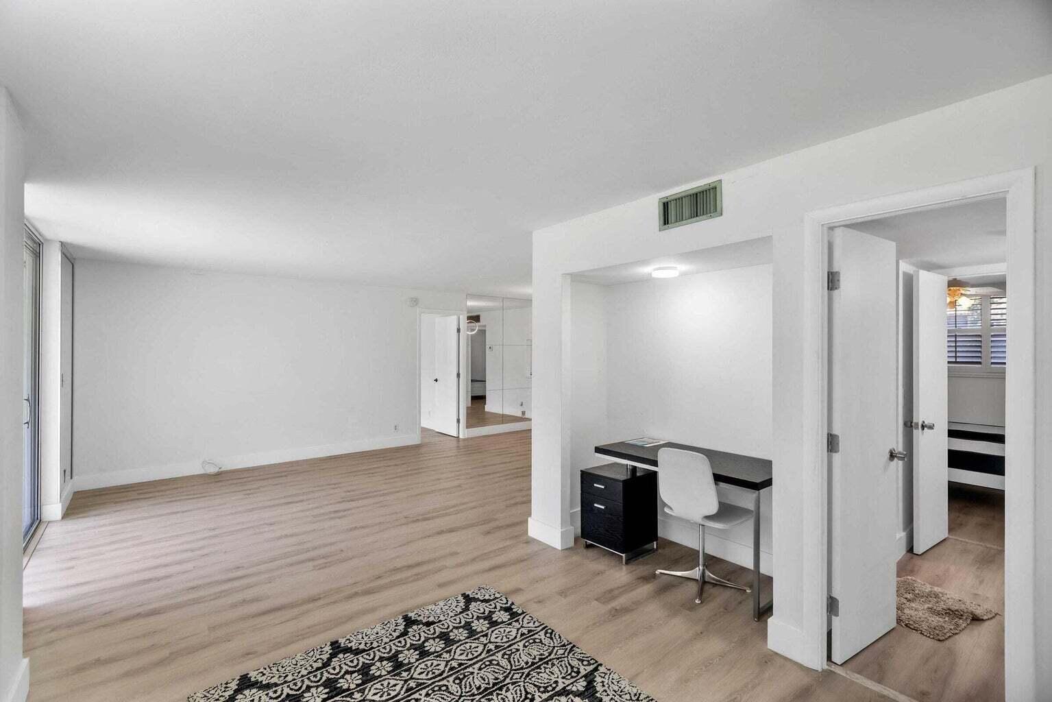 299 Northwest 52nd Terrace, Unit 118 Boca Raton, FL 33487 - Photo 6 of 28 a view of a livingroom with furniture and a hallway