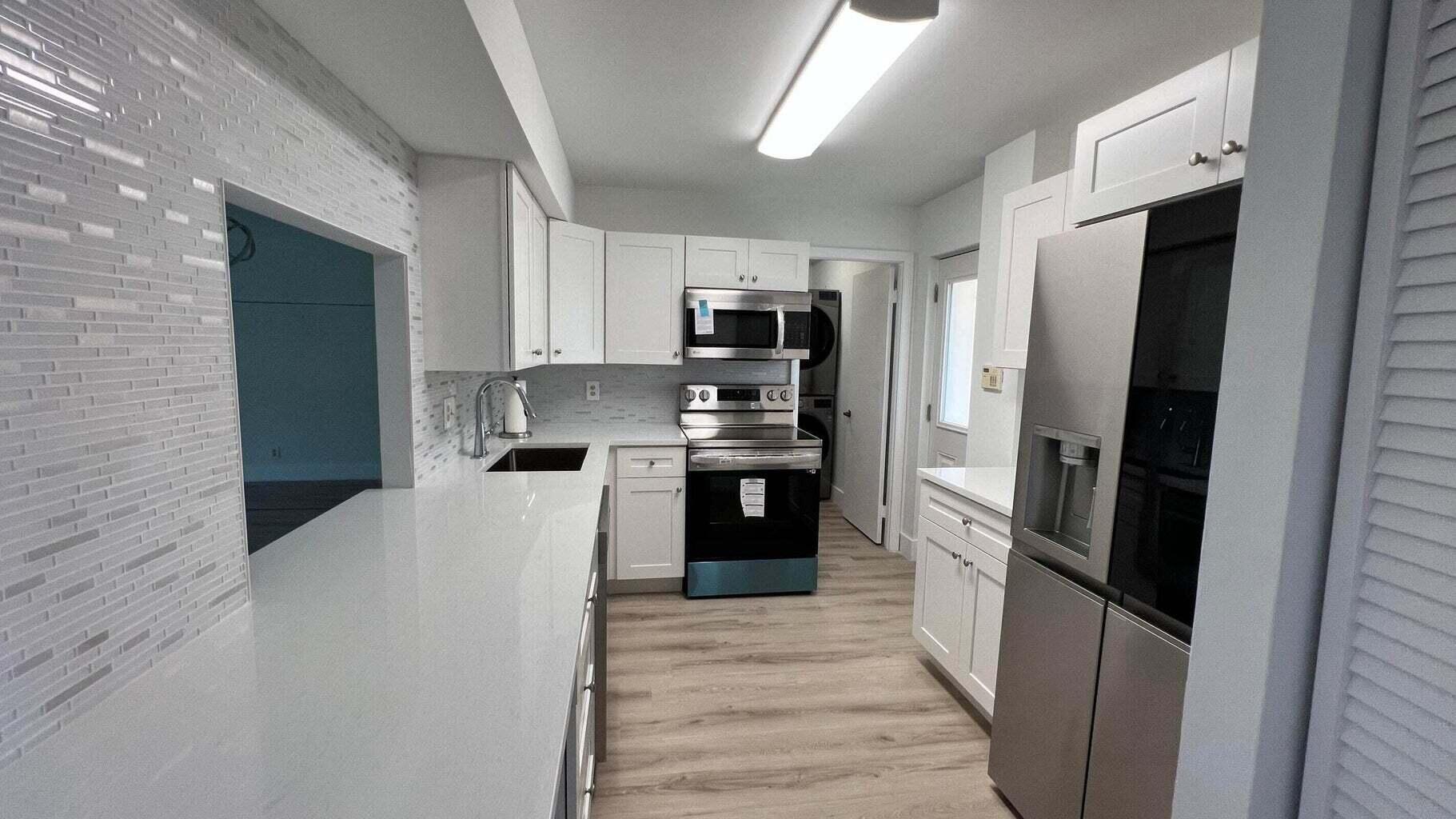 299 Northwest 52nd Terrace, Unit 118 Boca Raton, FL 33487 - Photo 10 of 28 a kitchen with stainless steel appliances a refrigerator and a stove
