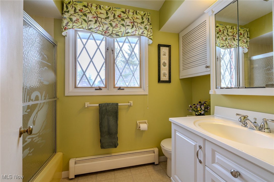 535 Barrington Ridge Road Painesville, OH 44077 - Photo 39 of 48 Full bathroom with vanity, a baseboard radiator, combined bath / shower with glass door, and toilet