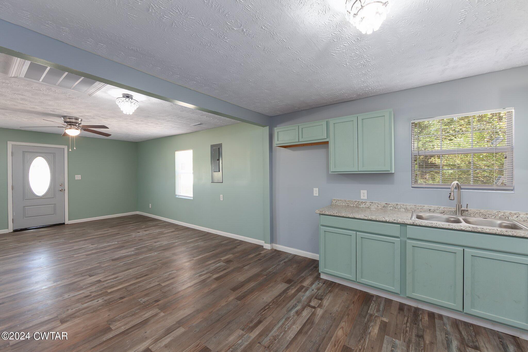 62 Everett Street Jackson, TN 38301 - Photo 11 of 28 a kitchen with a sink cabinets and wooden floor