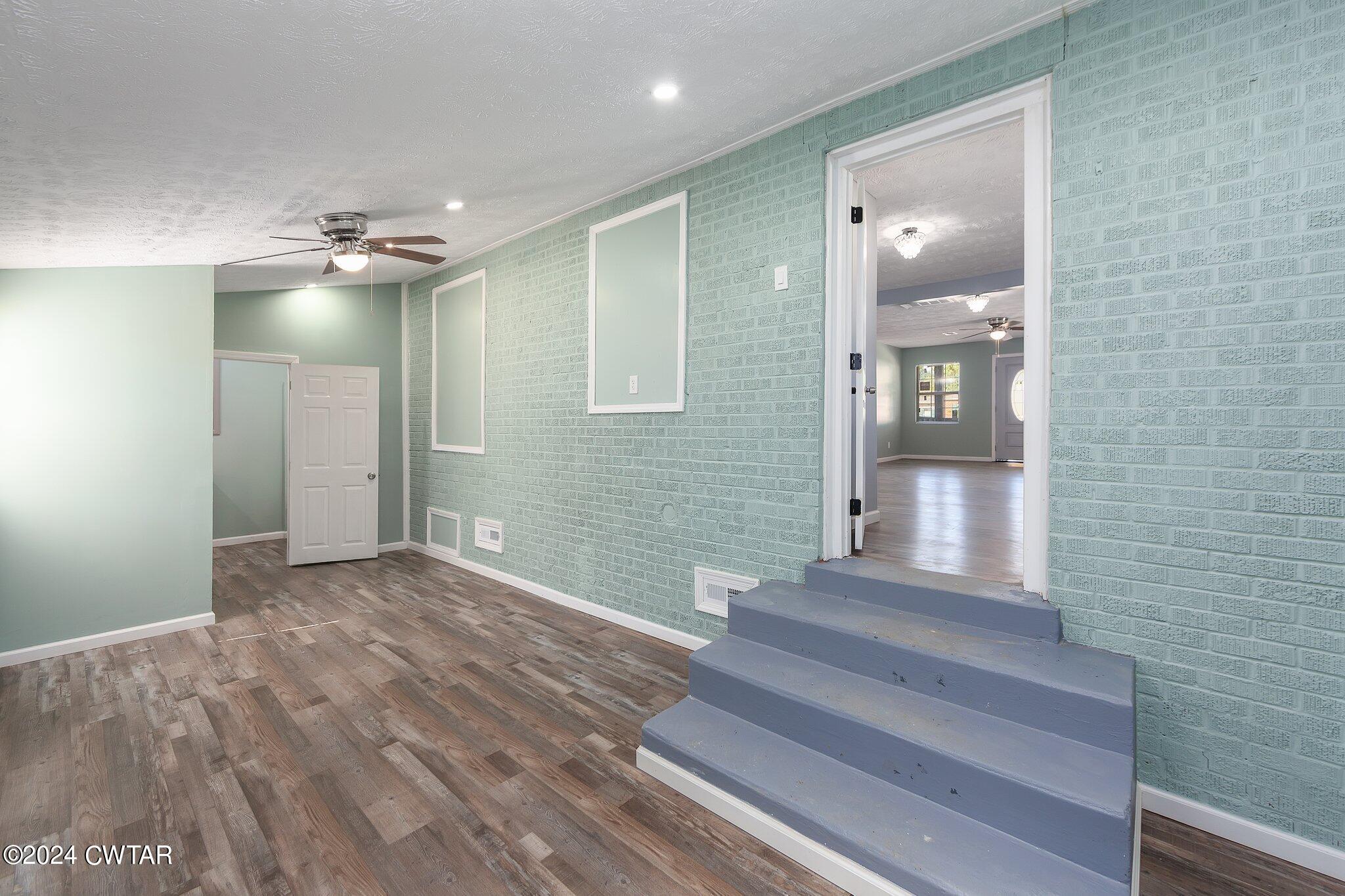 62 Everett Street Jackson, TN 38301 - Photo 13 of 28 a view of a hallway with front door and wooden floor