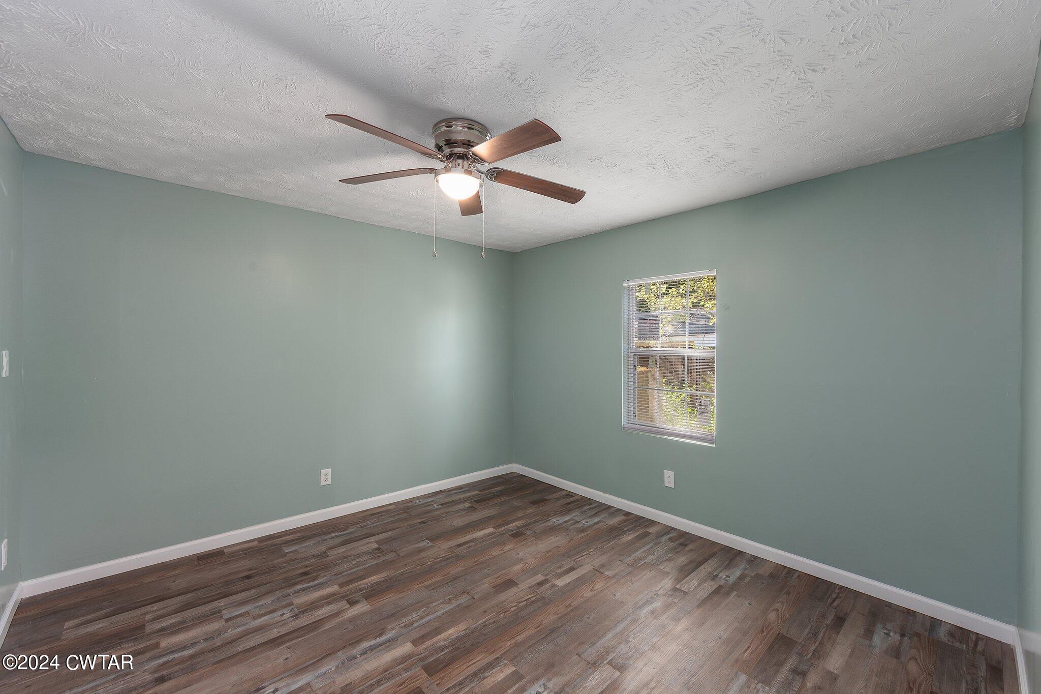 62 Everett Street Jackson, TN 38301 - Photo 18 of 28 wooden floor in an empty room with a window
