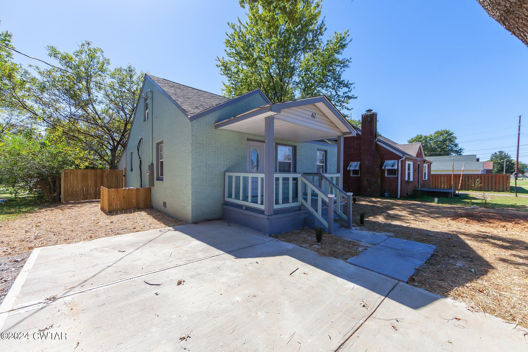 62 Everett Street Jackson, TN 38301 - Photo 2 of 28 a front view of a house with a yard