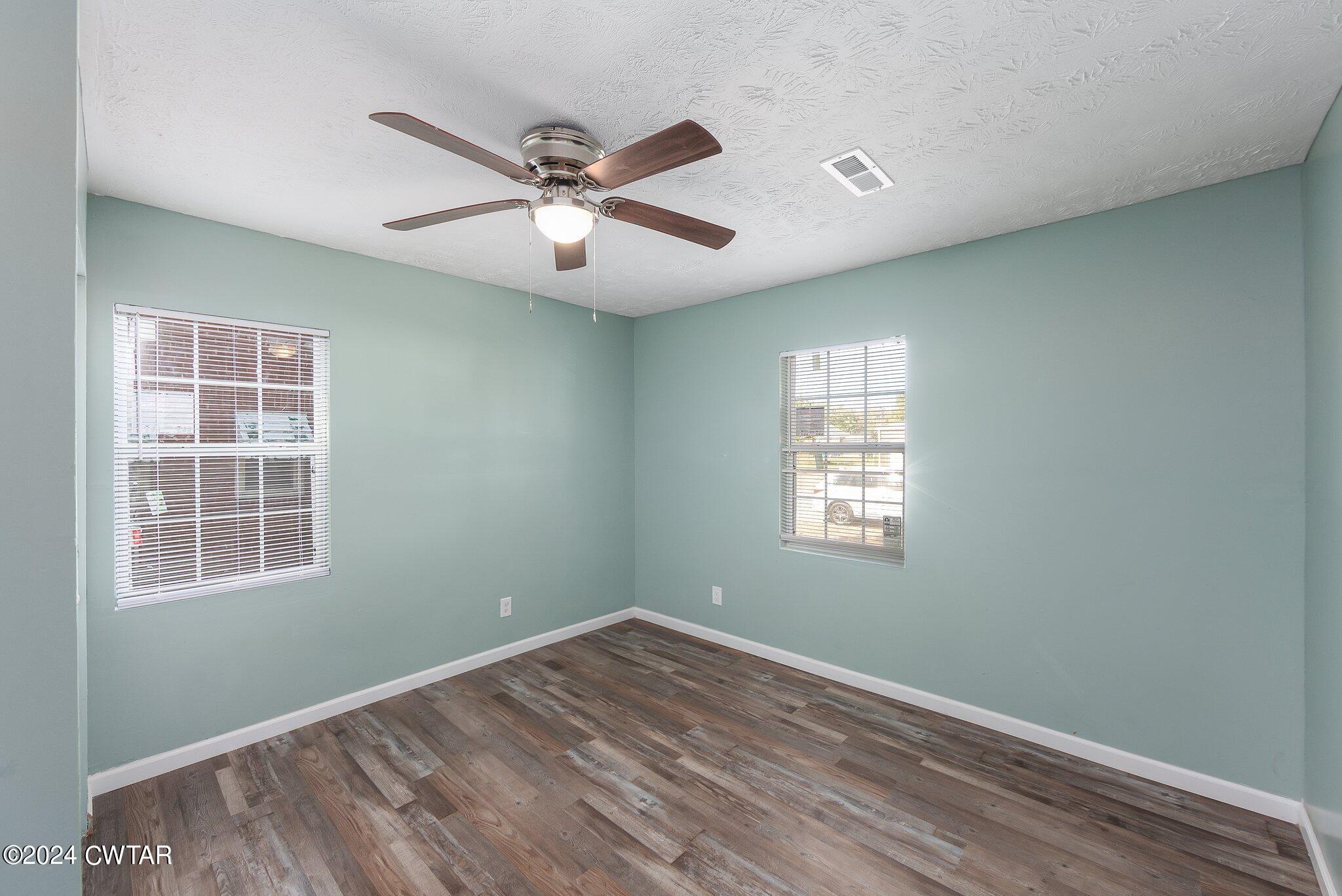 62 Everett Street Jackson, TN 38301 - Photo 21 of 28 a view of empty room with wooden floor and fan
