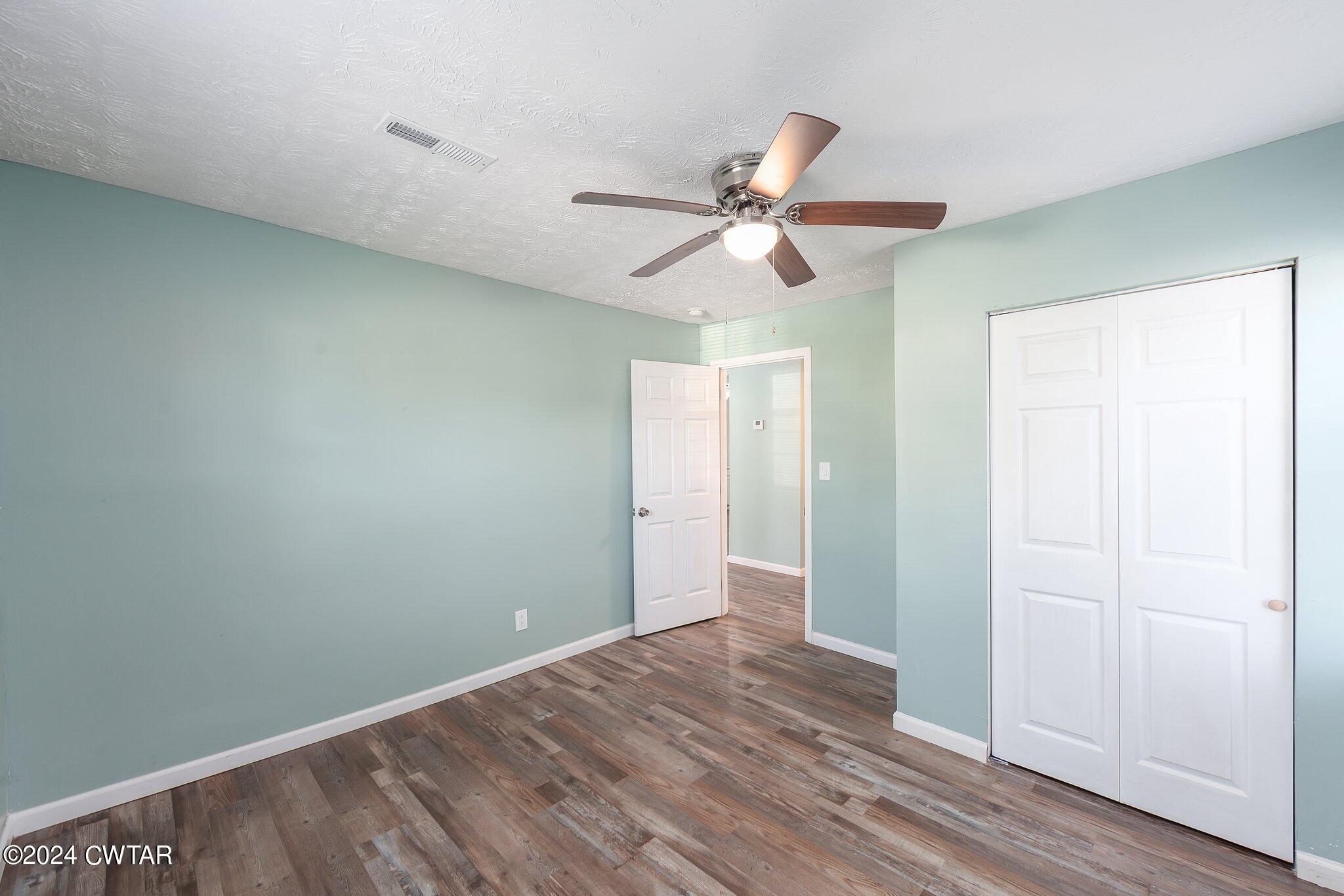 62 Everett Street Jackson, TN 38301 - Photo 22 of 28 a view of a big room with wooden floor and windows in a room