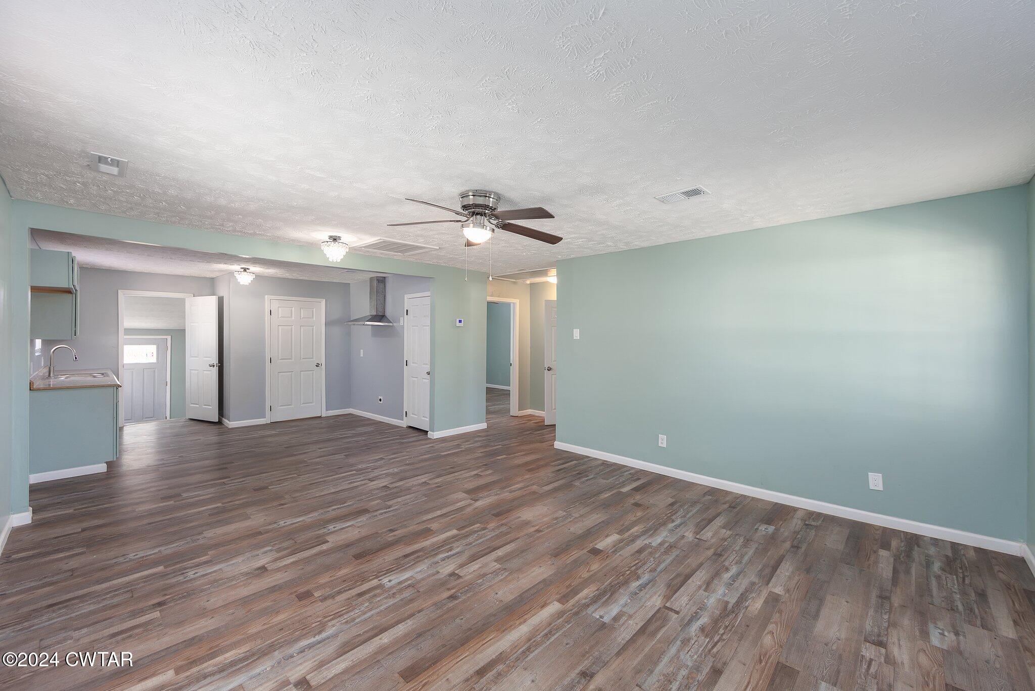 62 Everett Street Jackson, TN 38301 - Photo 5 of 28 wooden floor in an empty room with a window