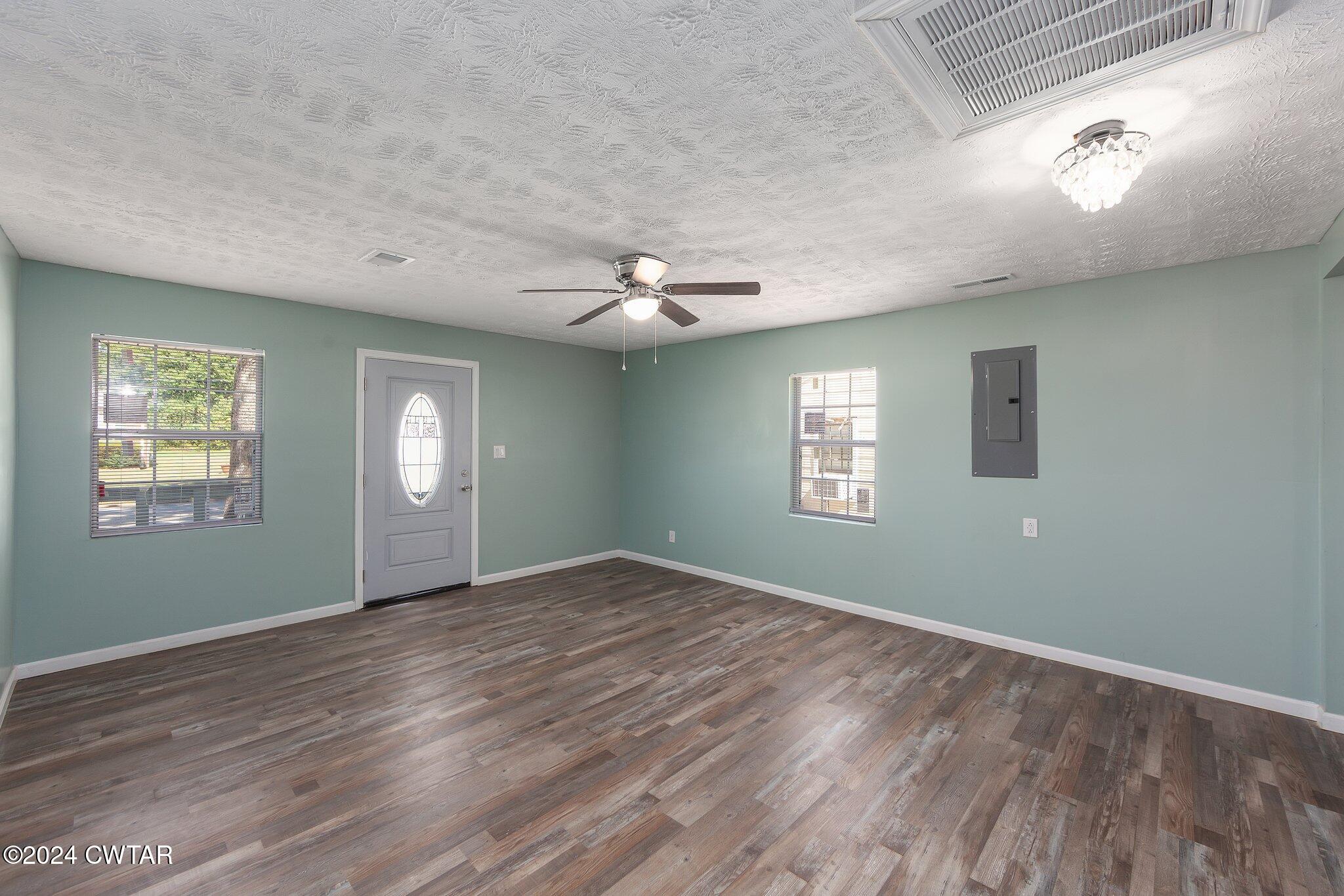 62 Everett Street Jackson, TN 38301 - Photo 7 of 28 a view of an empty room with window and wooden floor