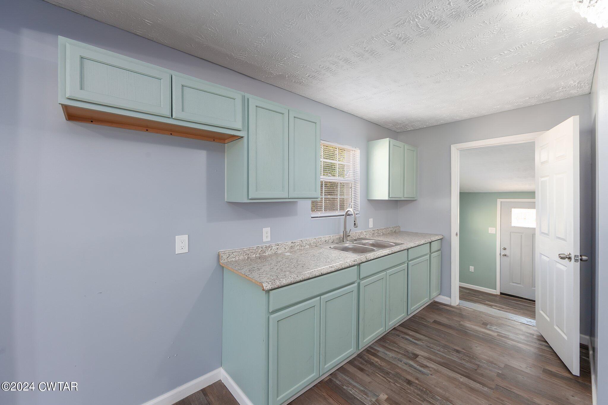 62 Everett Street Jackson, TN 38301 - Photo 8 of 28 a bathroom with a granite countertop sink and a mirror