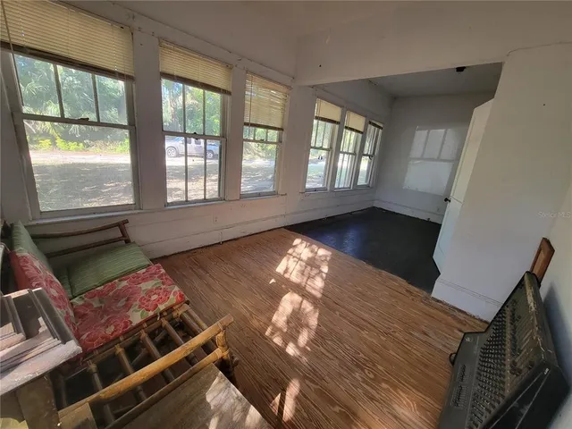 a hallway with a couch and a window