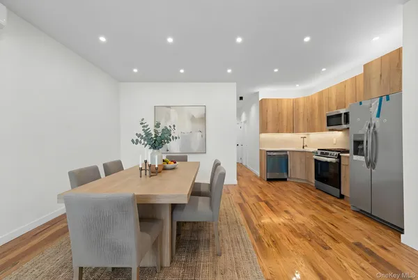 a kitchen with granite countertop a refrigerator and a dining table