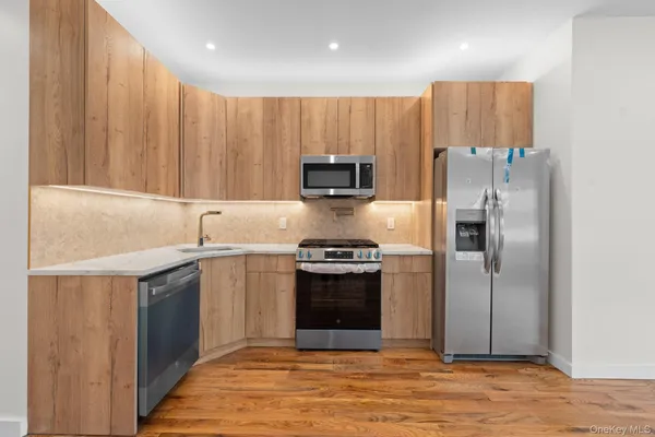 a kitchen with stainless steel appliances granite countertop a refrigerator and a sink