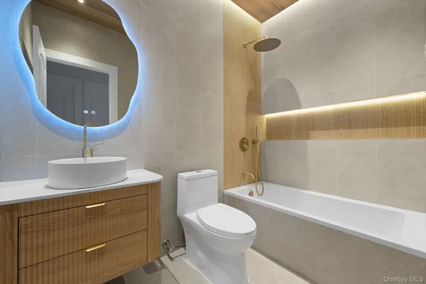 a bathroom with a toilet a sink and bathtub