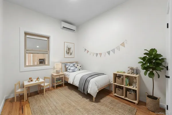 a bedroom with a bed and a potted plant