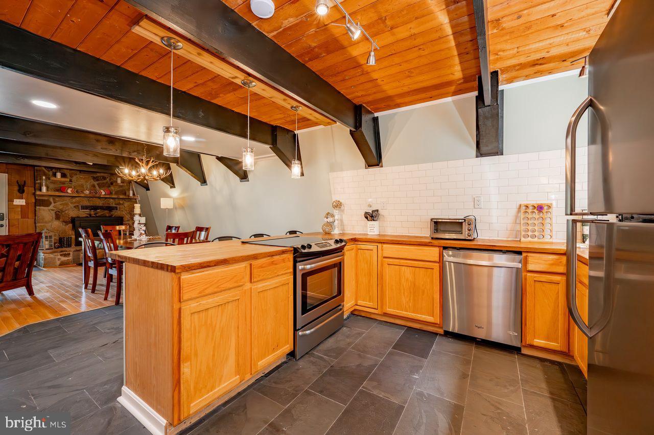 2678 Mayhew Inn Road Oakland, MD 21550 - Photo 13 of 33 Charming kitchen with rustic wooden beams.