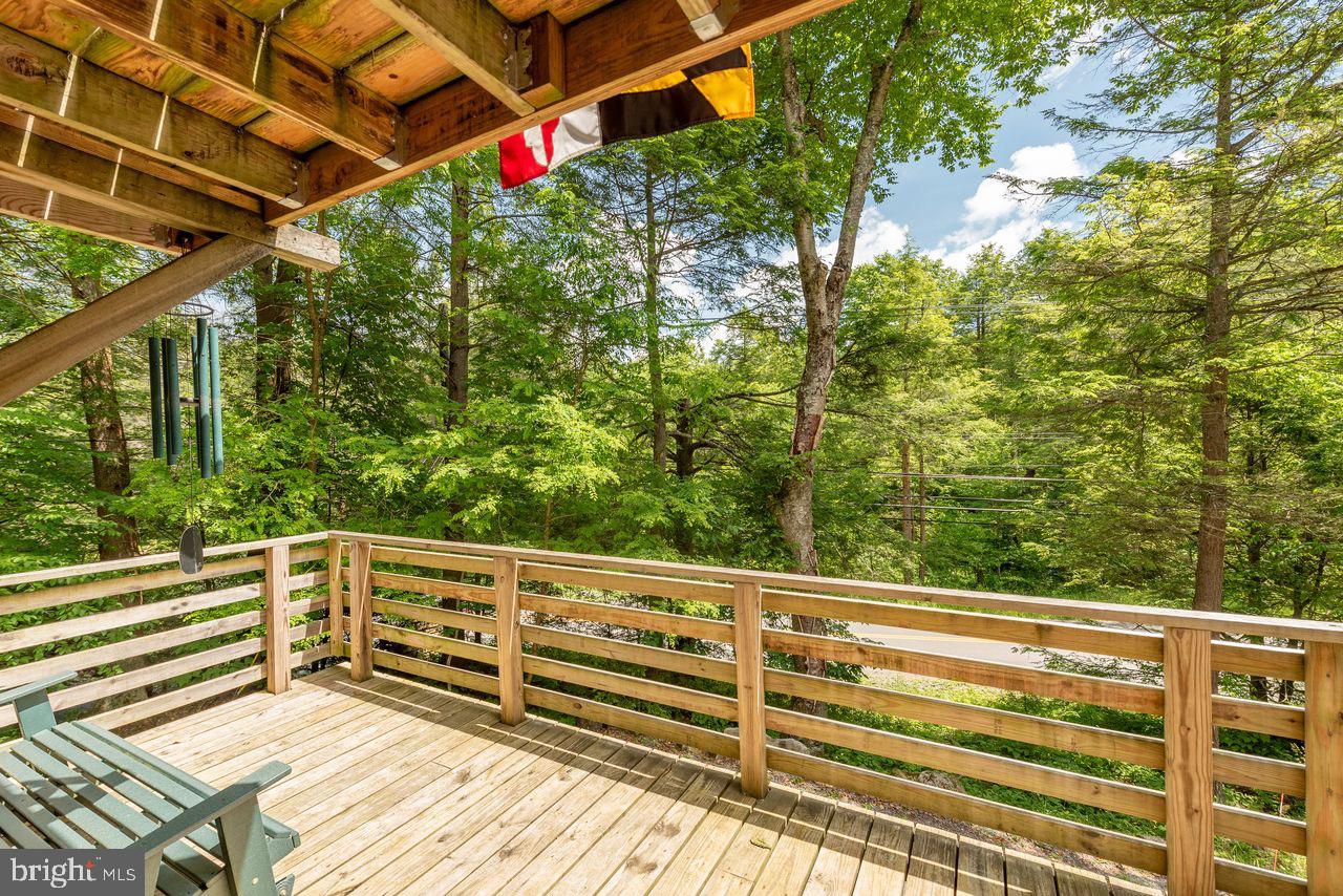 2678 Mayhew Inn Road Oakland, MD 21550 - Photo 6 of 33 Serene deck overlooking lush greenery.