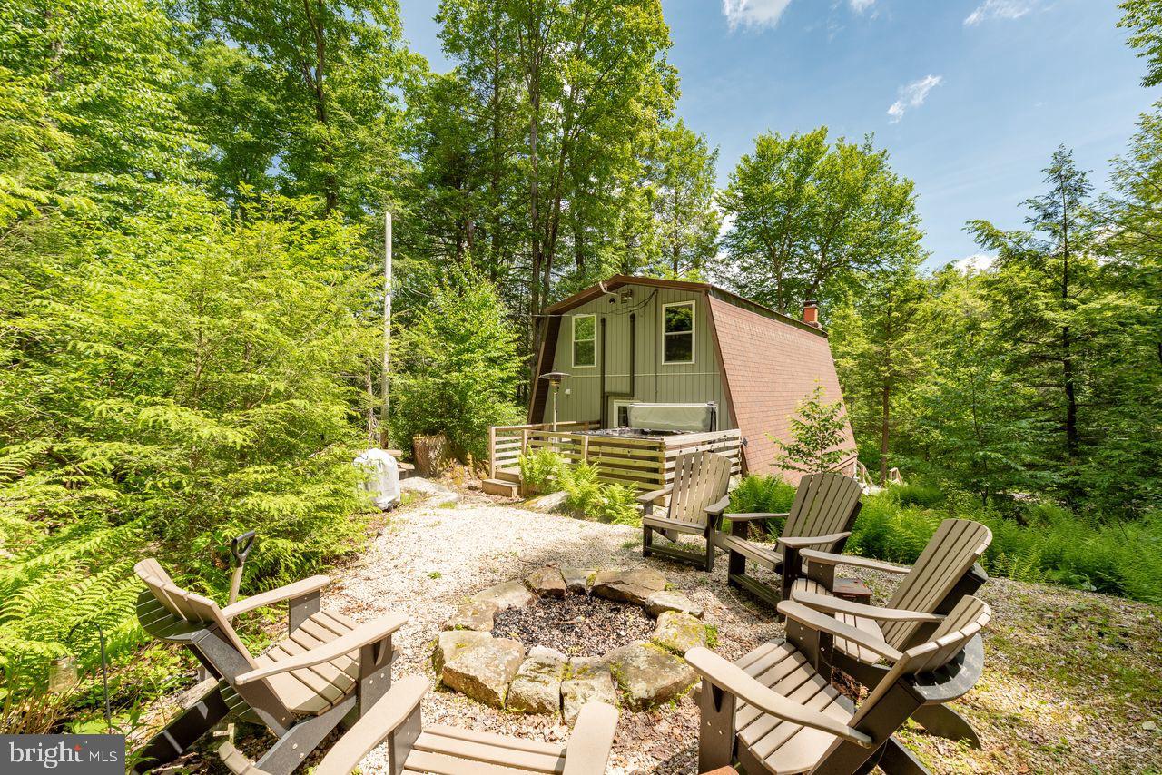 2678 Mayhew Inn Road Oakland, MD 21550 - Photo 8 of 33 Charming cabin nestled in lush greenery.