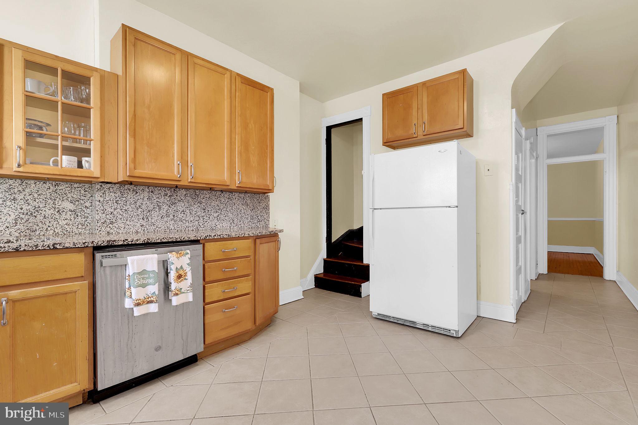 2511 North Calvert Street Baltimore, MD 21218 - Photo 13 of 37 a kitchen with cabinets and refrigerator