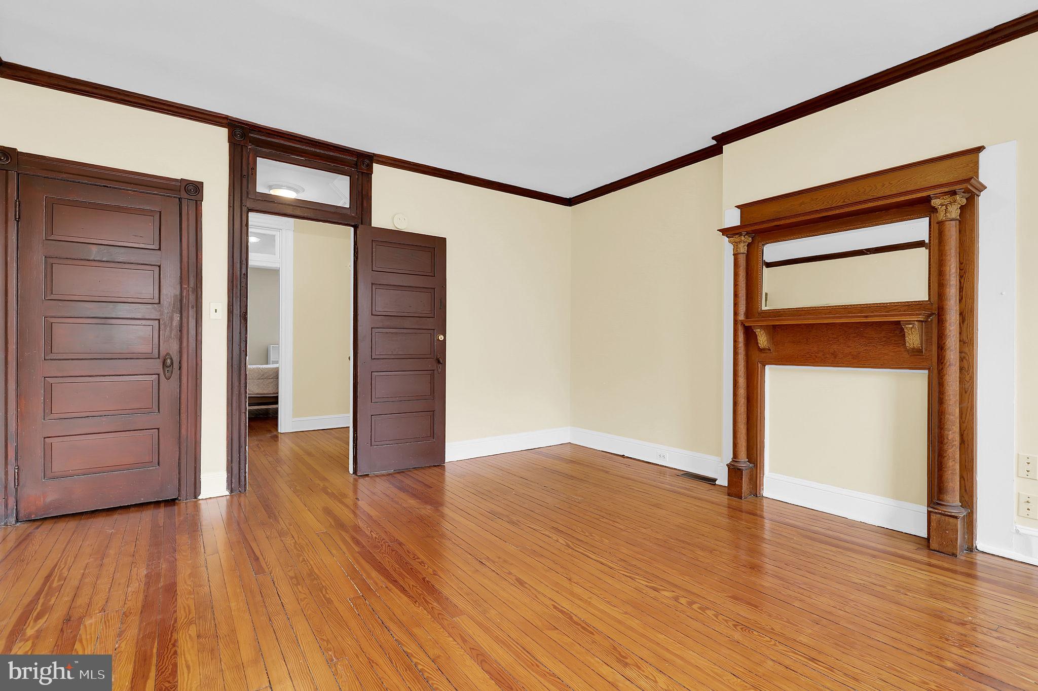 2511 North Calvert Street Baltimore, MD 21218 - Photo 21 of 37 an empty room with wooden floor & closet