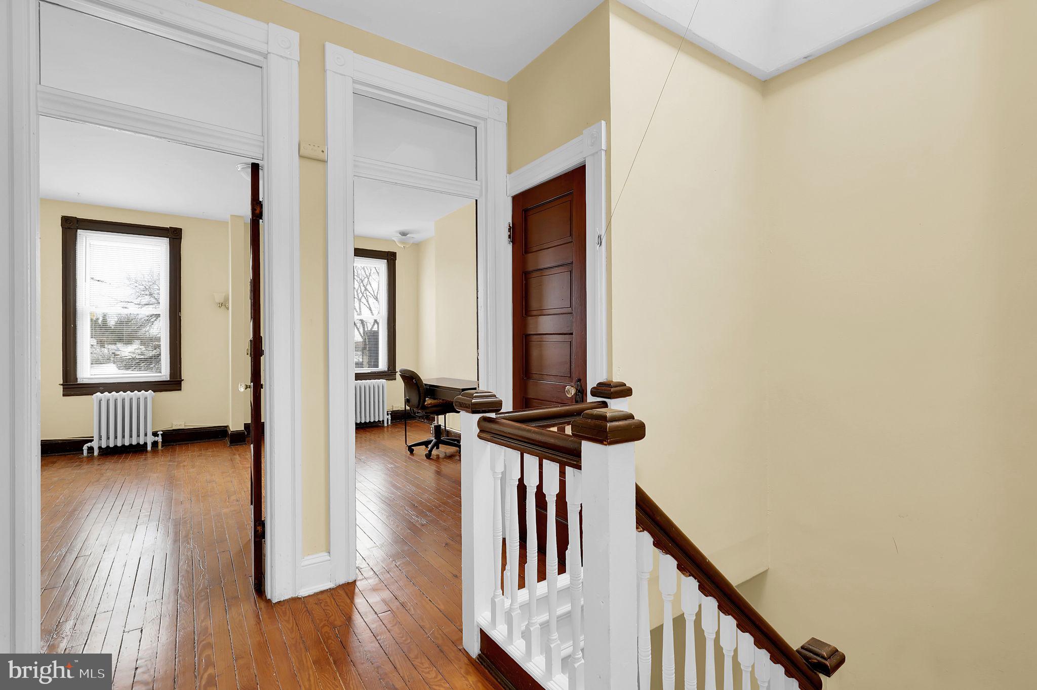 2511 North Calvert Street Baltimore, MD 21218 - Photo 22 of 37 a view of a hallway with wooden floor and windows