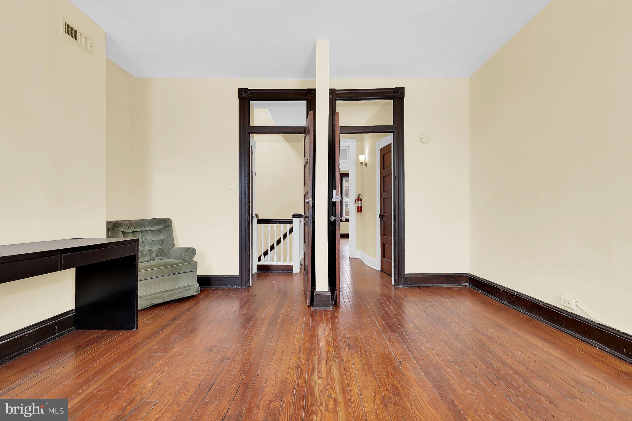 2511 North Calvert Street Baltimore, MD 21218 - Photo 26 of 37 wooden floor in an empty room