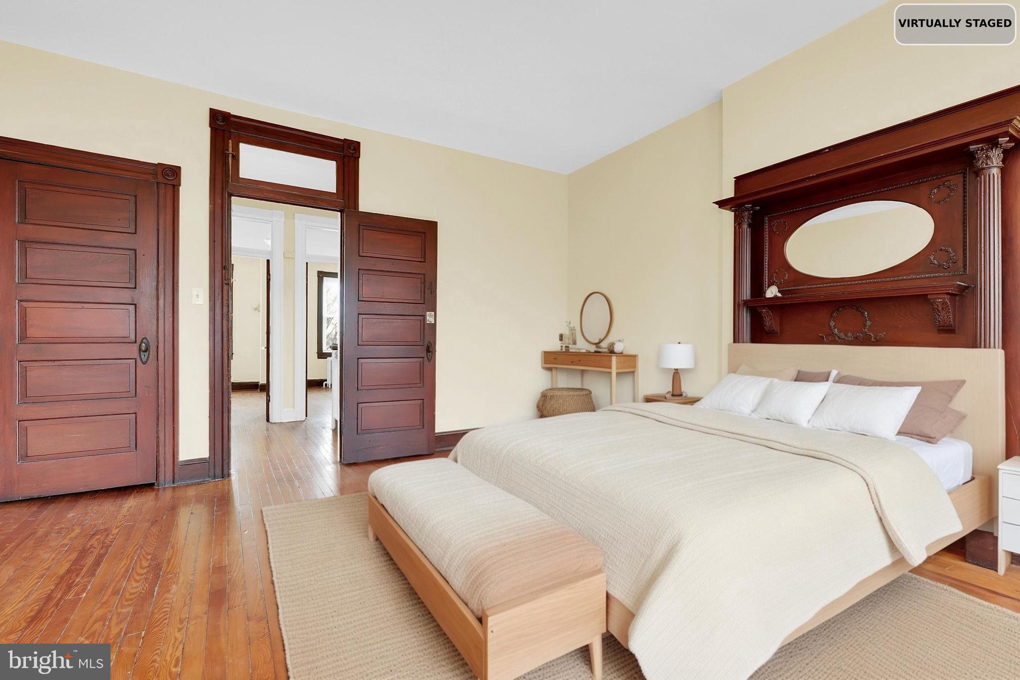 2511 North Calvert Street Baltimore, MD 21218 - Photo 28 of 37 a bedroom with a bed and wooden floor