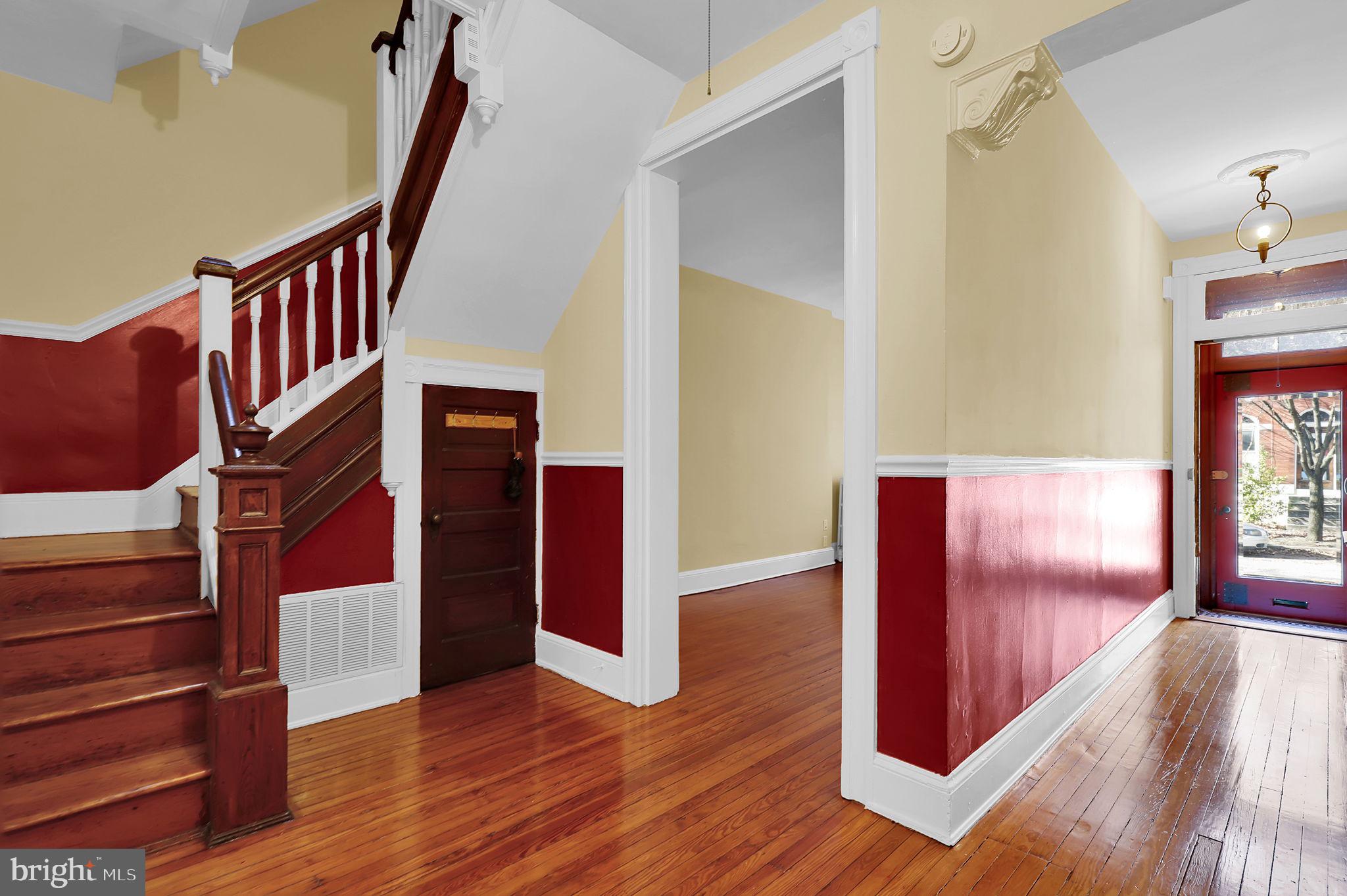 2511 North Calvert Street Baltimore, MD 21218 - Photo 3 of 37 a view of an entryway with wooden floor and door