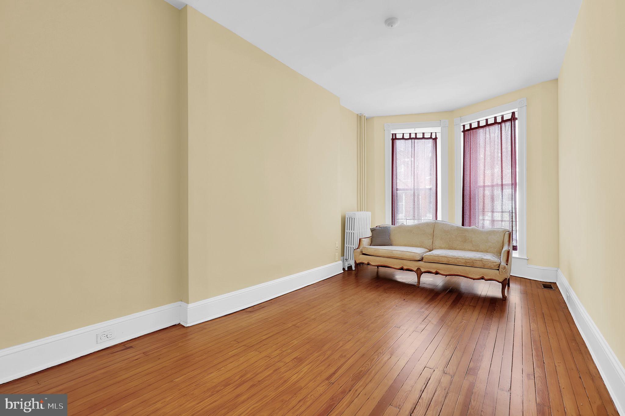 2511 North Calvert Street Baltimore, MD 21218 - Photo 5 of 37 a living room with furniture and a wooden floor