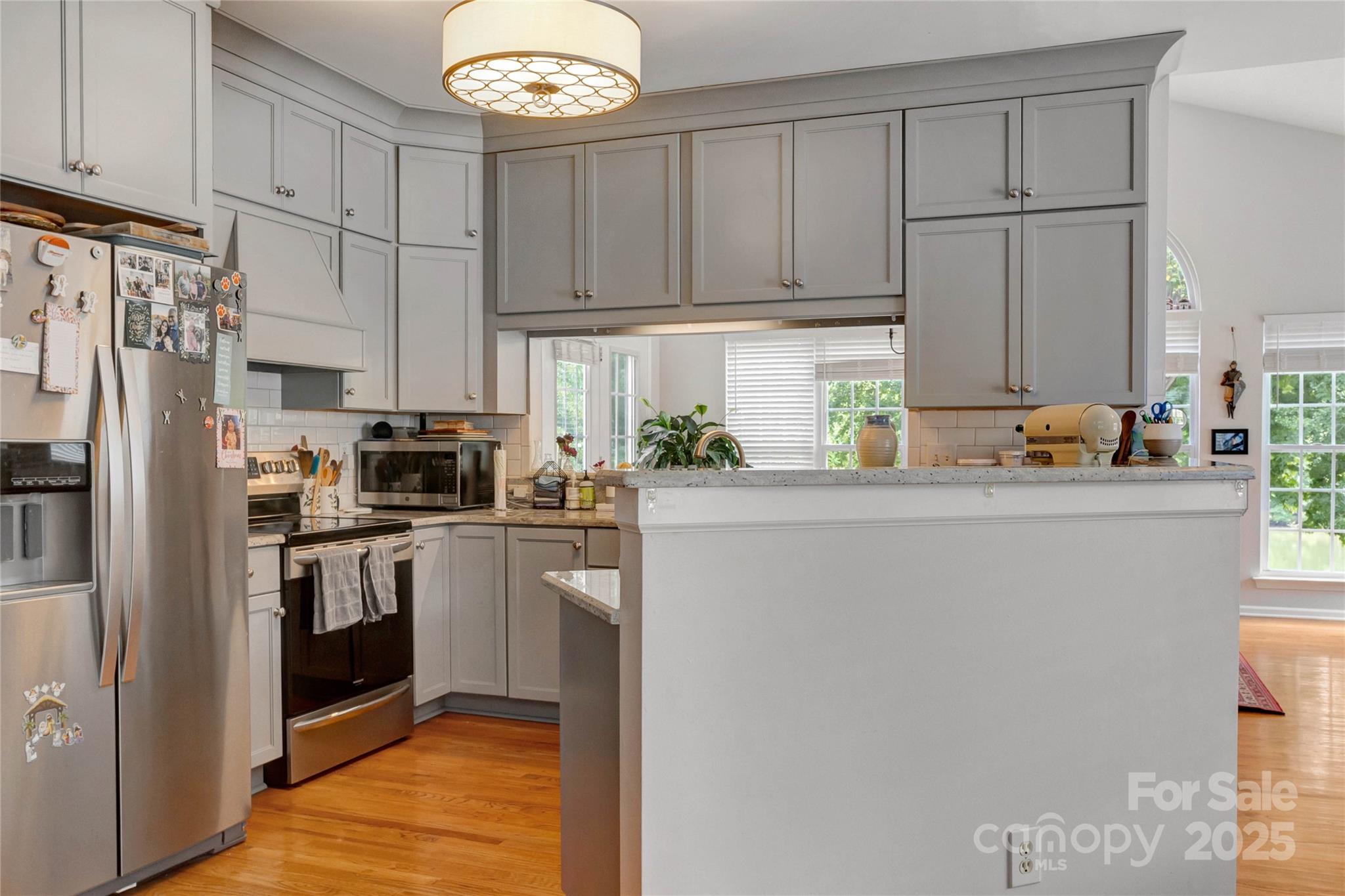 132 Lighthouse Road Mount Holly, NC 28120 - Photo 4 of 43 a kitchen with stainless steel appliances granite countertop a refrigerator sink and cabinets