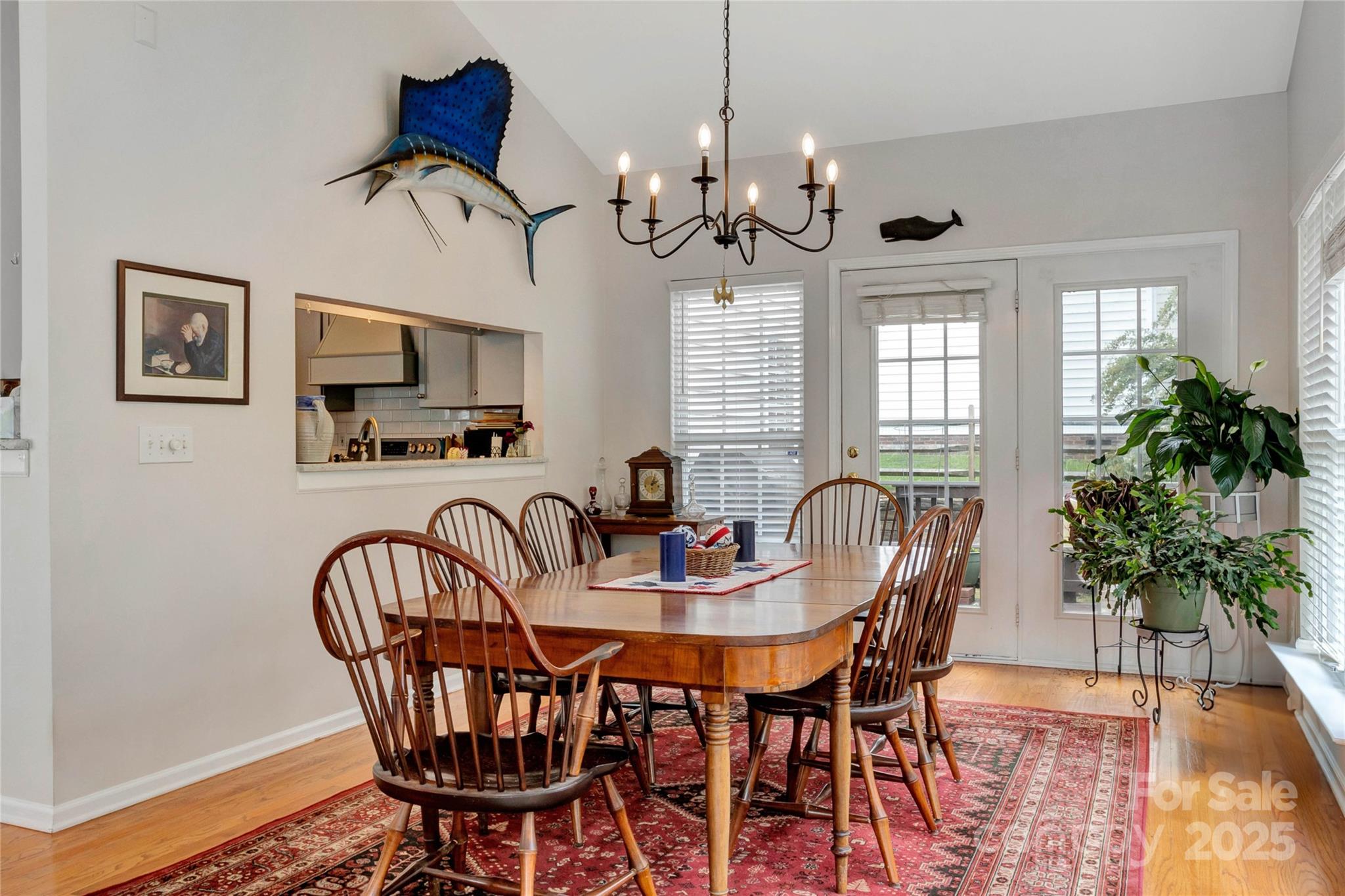 132 Lighthouse Road Mount Holly, NC 28120 - Photo 8 of 43 a view of a dining room with furniture a chandelier and wooden floor