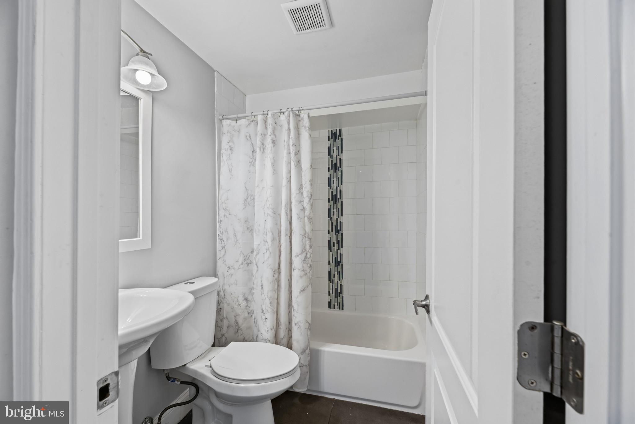 353 Leeanne Road Essex, MD 21221 - Photo 12 of 29 a bathroom with a toilet and a shower