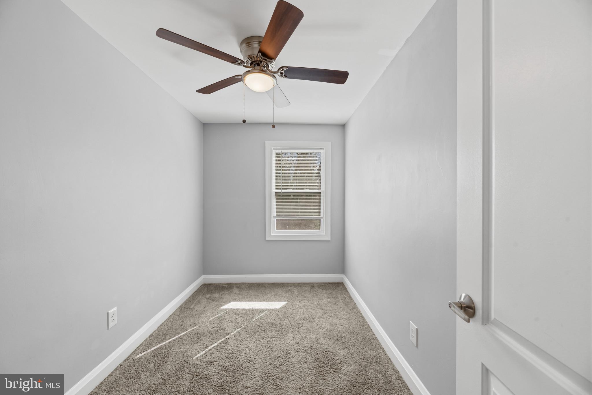 353 Leeanne Road Essex, MD 21221 - Photo 15 of 29 an empty room with a window and a fan