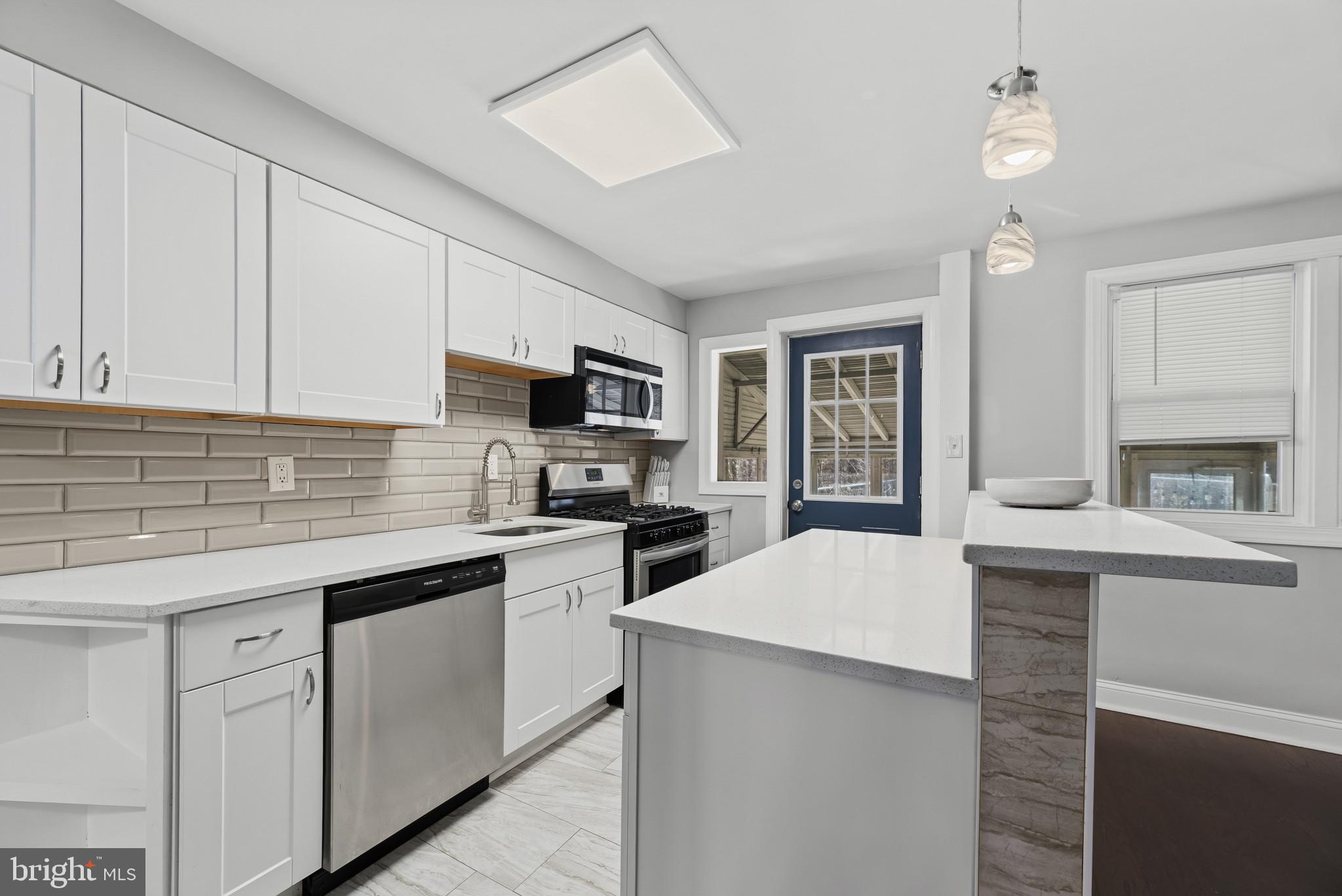 353 Leeanne Road Essex, MD 21221 - Photo 7 of 29 a kitchen with cabinets appliances a sink and a window