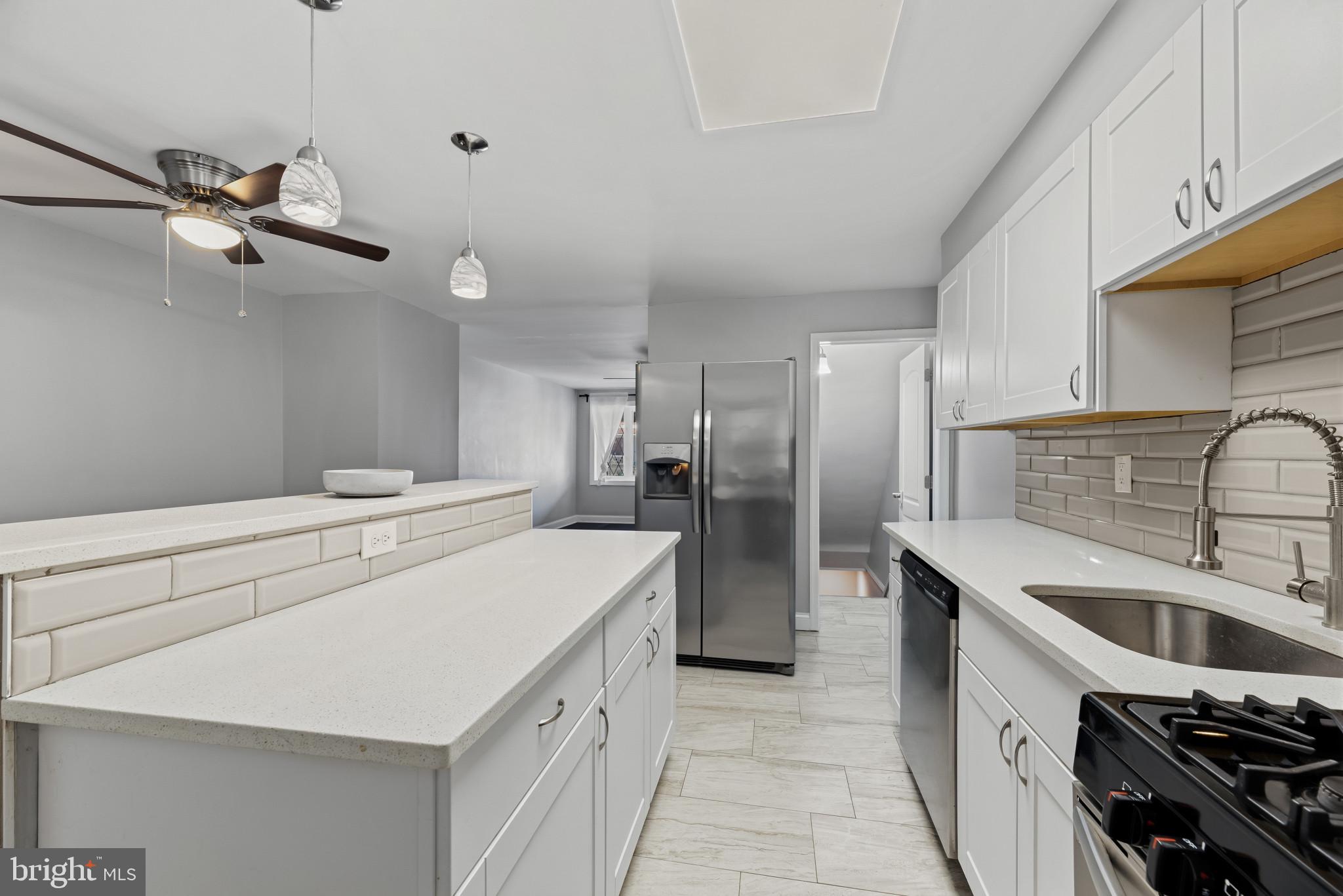 353 Leeanne Road Essex, MD 21221 - Photo 8 of 29 a kitchen that has a sink stainless steel appliances and cabinets