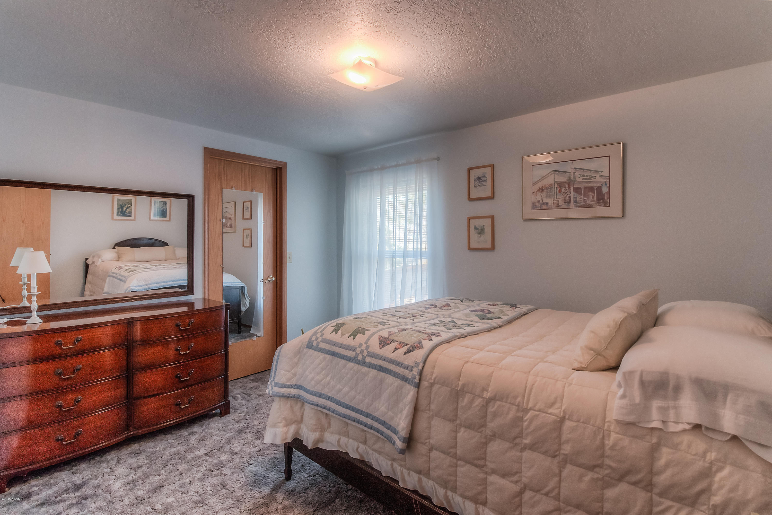 350 Schraeder Road Tieton, WA 98947 - Photo 25 of 39 a bedroom with a bed and a dresser in it