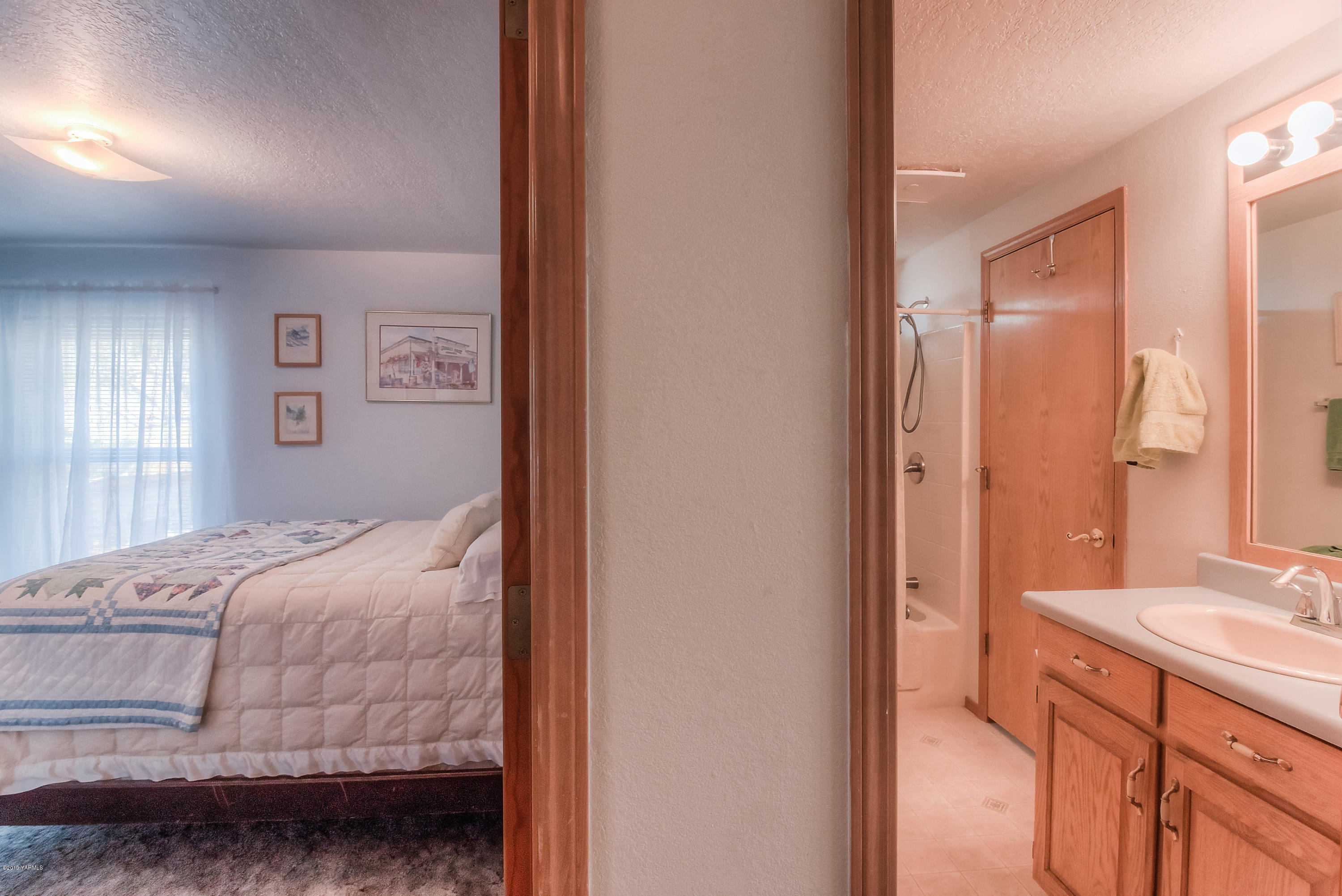 350 Schraeder Road Tieton, WA 98947 - Photo 26 of 39 a bedroom with a bed and a double vanity sink