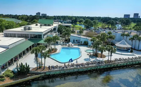 a view of a livingroom with lounge chair and a large window