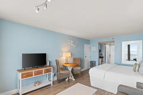 a bedroom with furniture and a flat screen tv