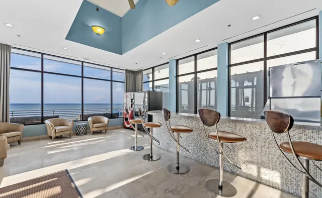 a living room with furniture and a floor to ceiling window